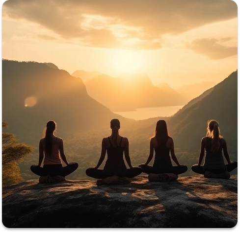 People meditating on mountain during sunset